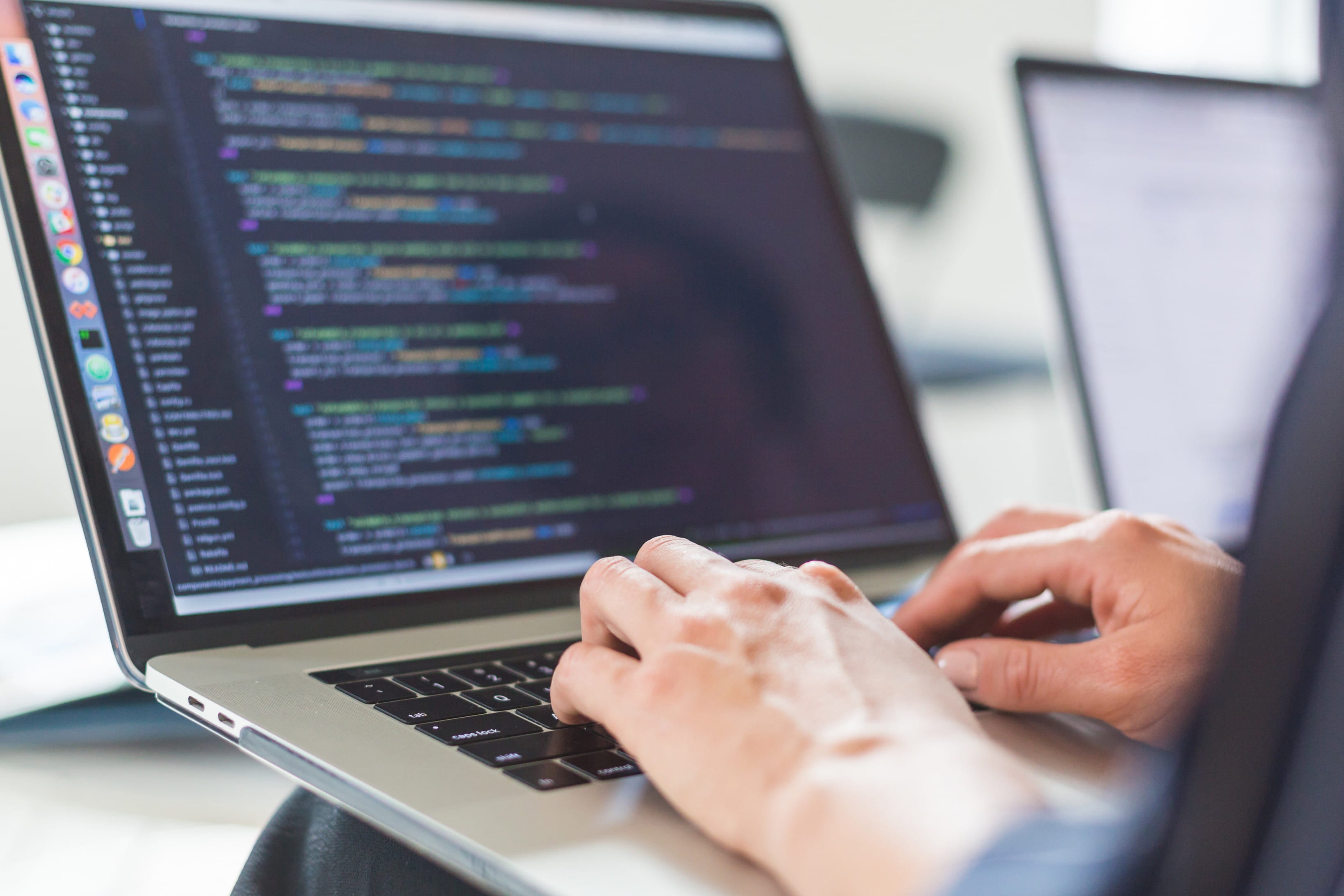 a person coding on a laptop