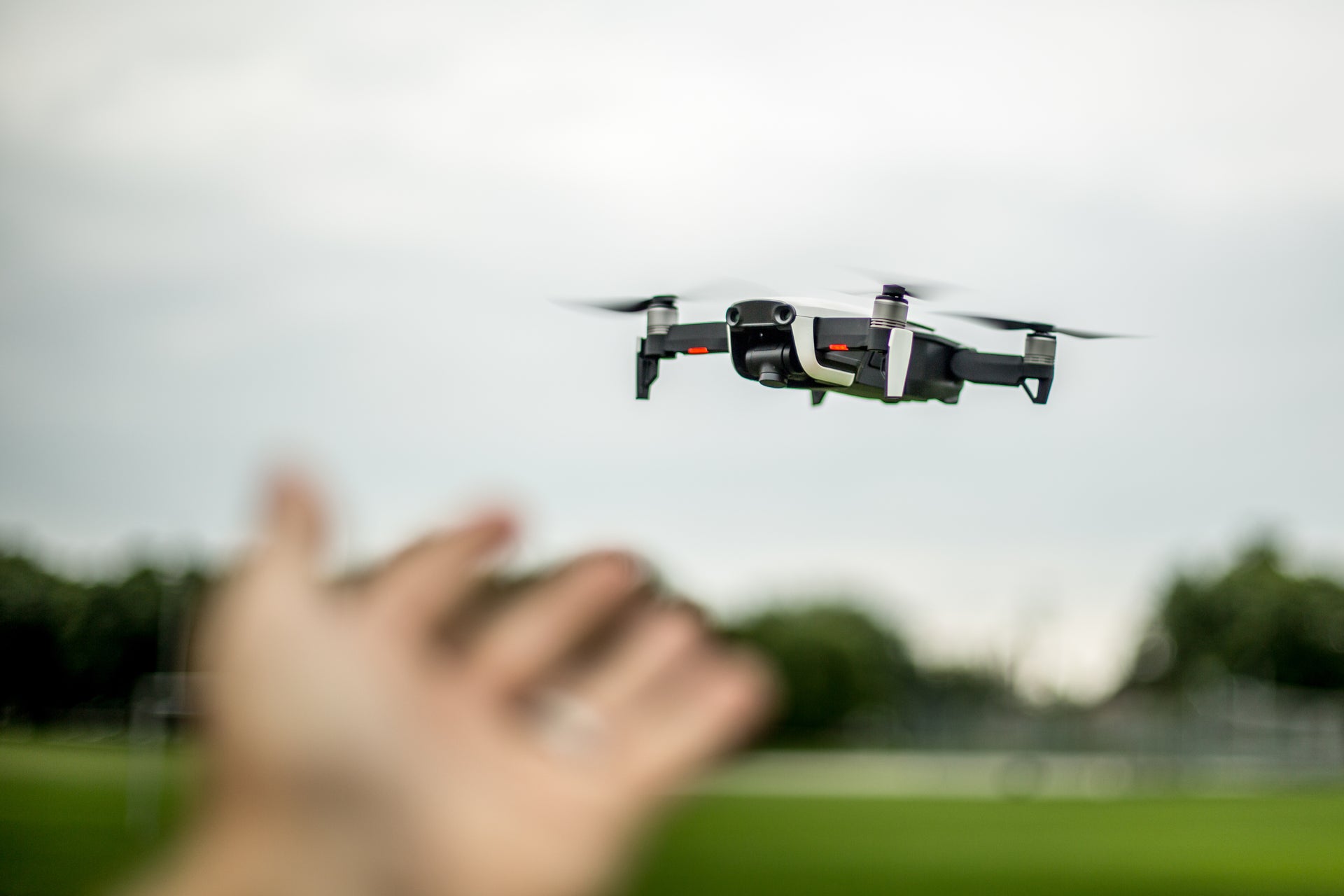 a hand reaching out to receive drone