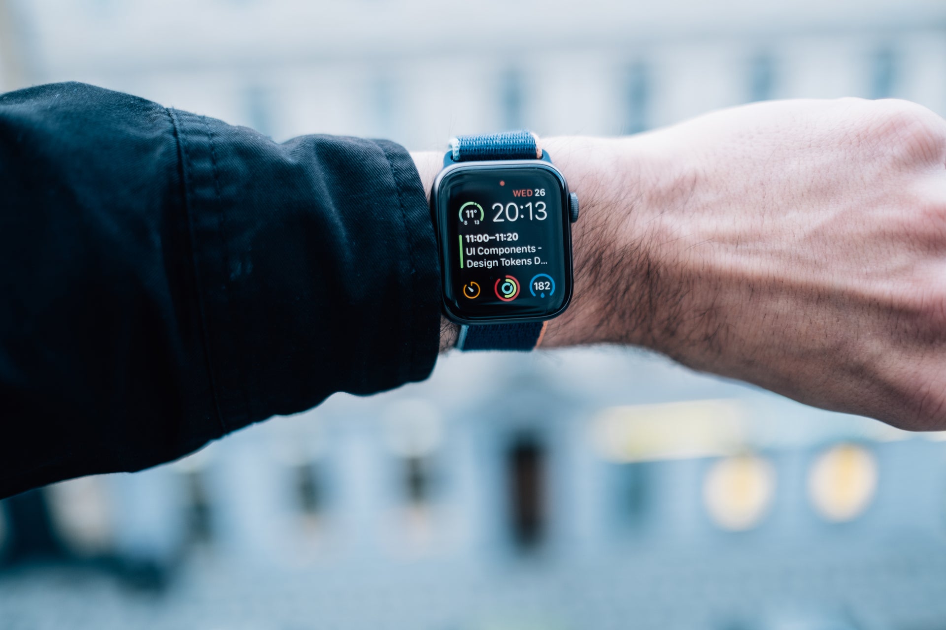 A person's wrist wearing a smartwatch which shows the date